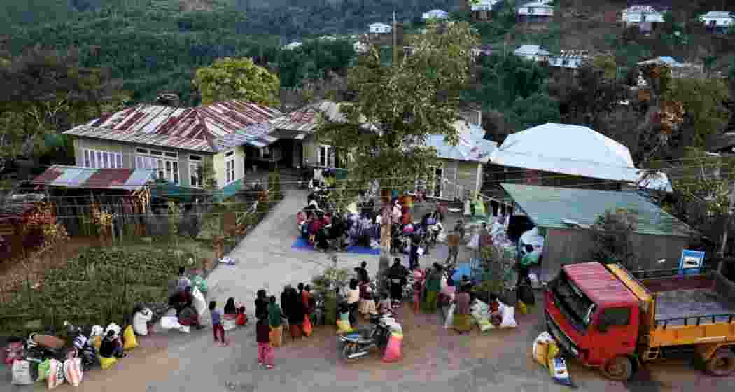 Displaced individuals from Myanmar gather at a temporary relief centre near the India-Myanmar border in Mizoram to collect donated clothing amid ongoing unrest and cross-border displacement. Displaced individuals from Myanmar gather at a temporary relief centre near the India-Myanmar border in Mizoram to collect donated clothing amid ongoing unrest and cross-border displacement.