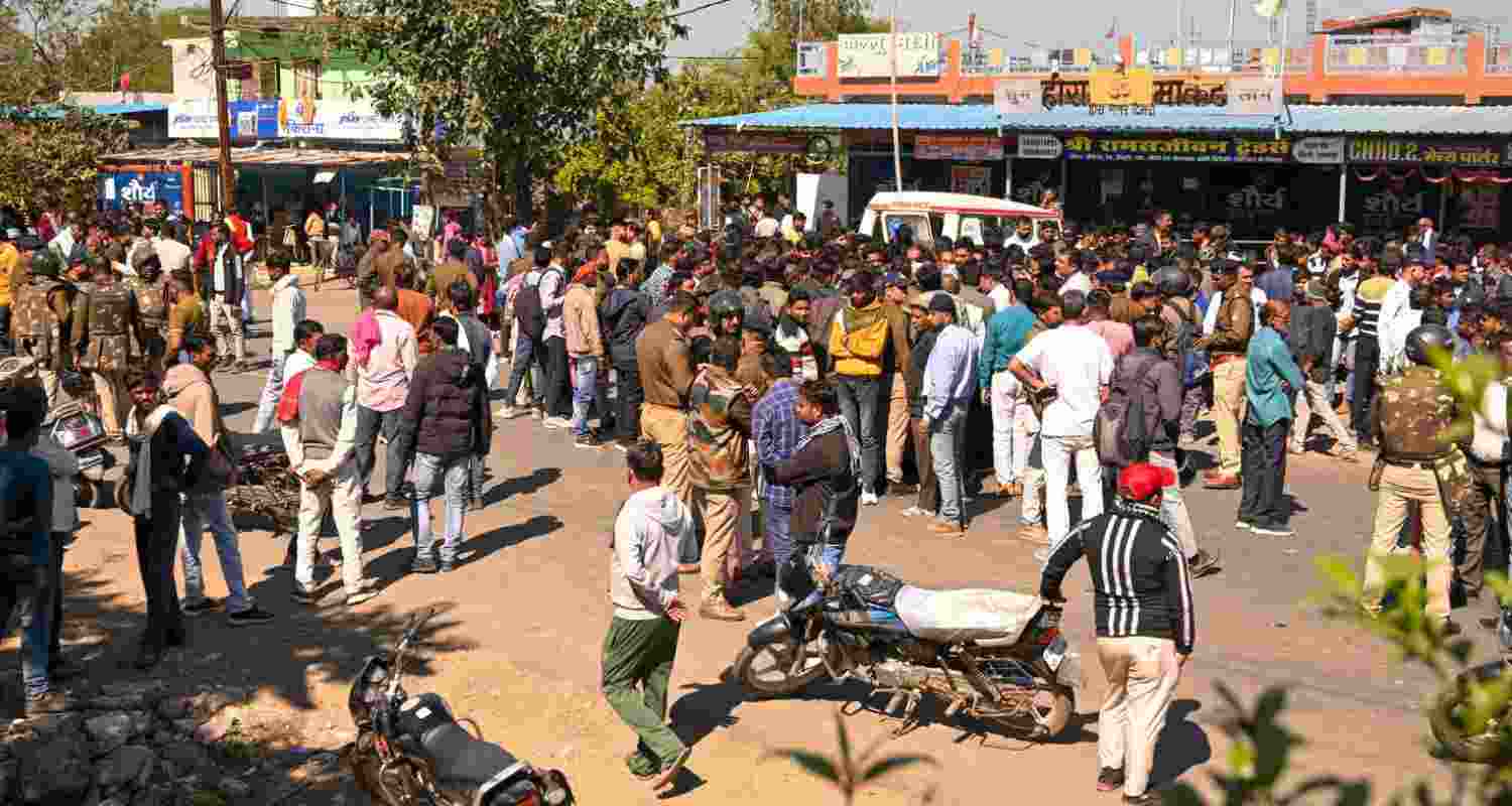 People gather amid heavy security after four men were killed and another person was injured following an attack by a group of people, at Timari village in Madhya Pradesh's Jabalpur district. People gather amid heavy security after four men were killed and another person was injured following an attack by a group of people, at Timari village in Madhya Pradesh's Jabalpur district.