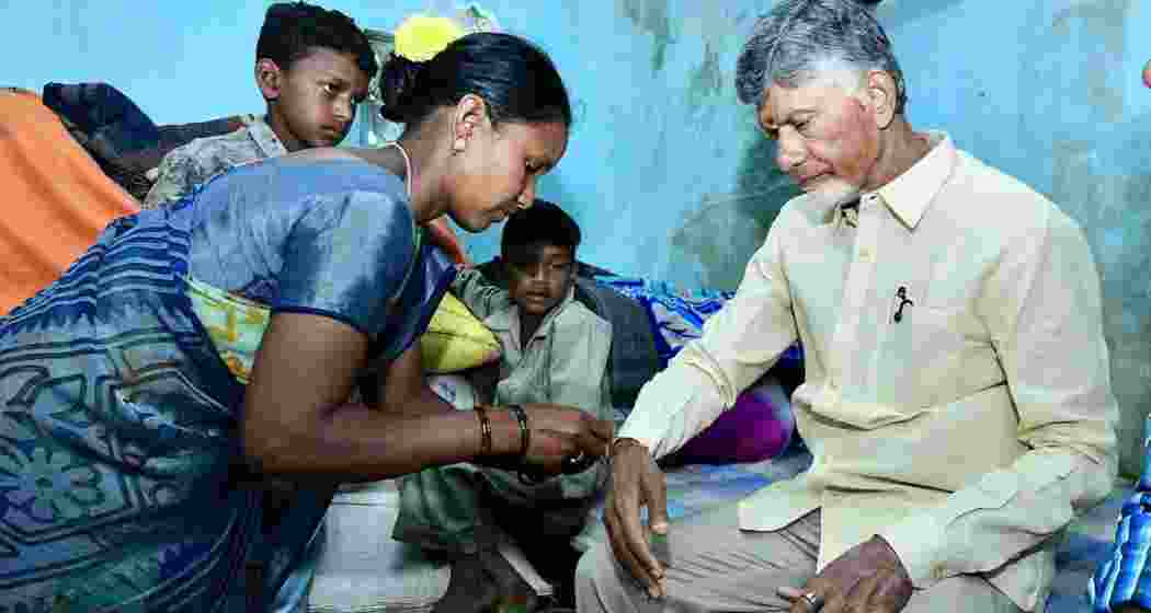 Chandrababu Naidu ties a rakhi presented by a tribal woman during World Tribal Day celebrations on Saturday. Chandrababu Naidu ties a rakhi presented by a tribal woman during World Tribal Day celebrations on Saturday.