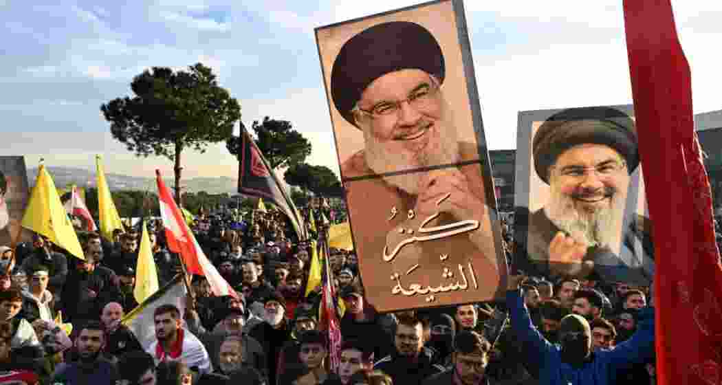 People wave flags and hold posters of Nasrallah ahead of his final journey, gathering in Beirut to pay tribute to the slain Hezbollah leader. People wave flags and hold posters of Nasrallah ahead of his final journey, gathering in Beirut to pay tribute to the slain Hezbollah leader.
