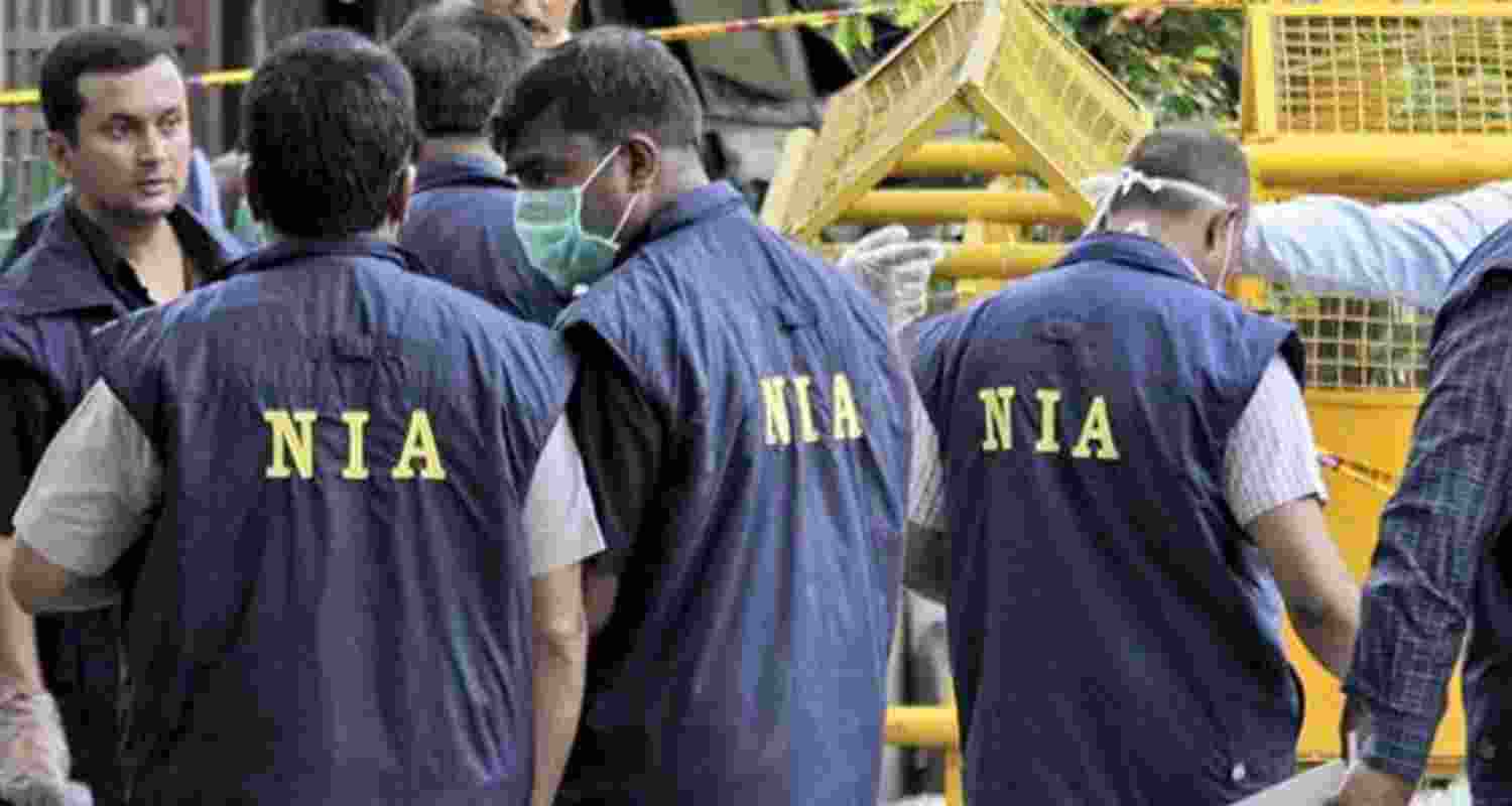 NIA personnel during raid. NIA personnel during raid.