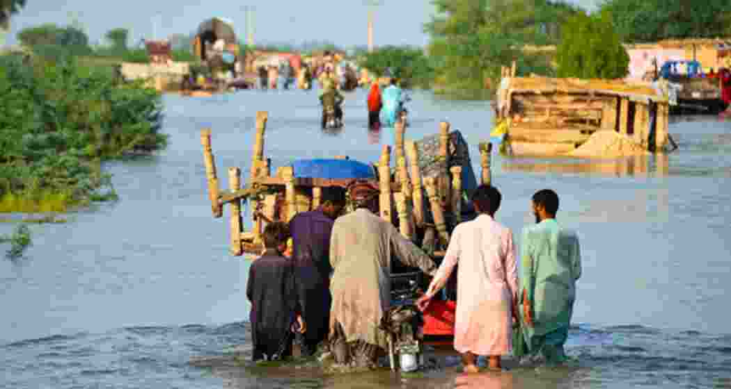 Residents wade through waist-deep floodwaters, pushing a cart along a submerged road in Pakistan’s Punjab province as monsoon rains continue to wreak havoc across the region. Residents wade through waist-deep floodwaters, pushing a cart along a submerged road in Pakistan’s Punjab province as monsoon rains continue to wreak havoc across the region.