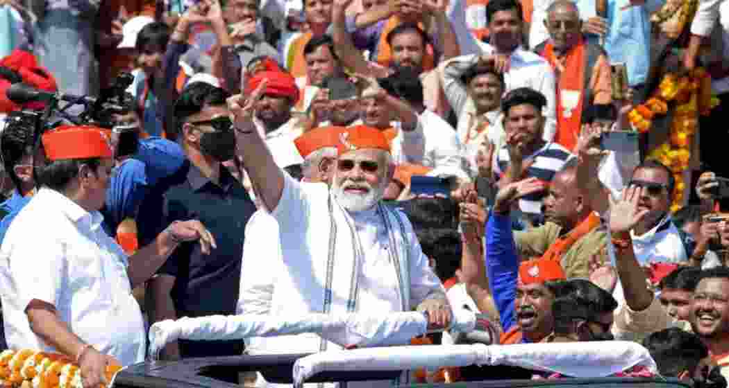 Prime Minister Narendra Modi waves to supporters during a rally in Gujarat. Prime Minister Narendra Modi waves to supporters during a rally in Gujarat.