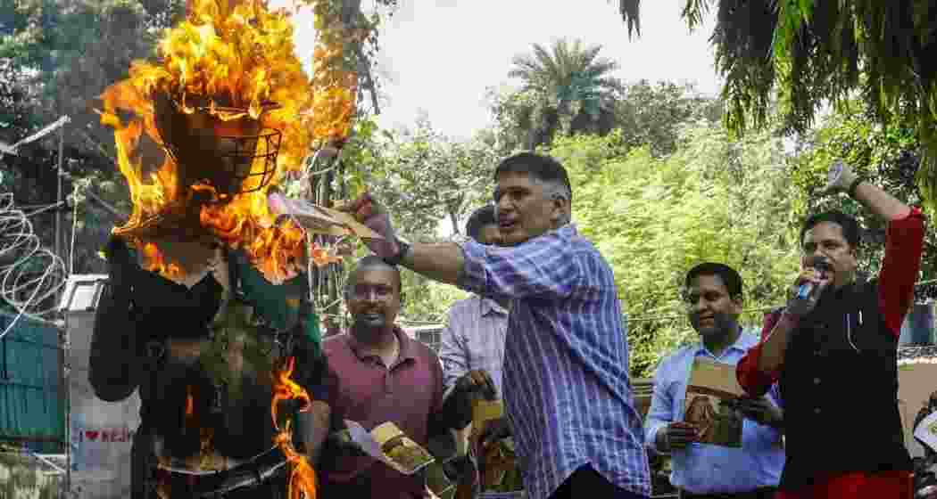 AAP leader Saurabh Bharadwaj burns an effigy during a protest against the upcoming Asia Cup cricket match between India and Pakistan, at the party office in New Delhi, Saturday. AAP leader Saurabh Bharadwaj burns an effigy during a protest against the upcoming Asia Cup cricket match between India and Pakistan, at the party office in New Delhi, Saturday.