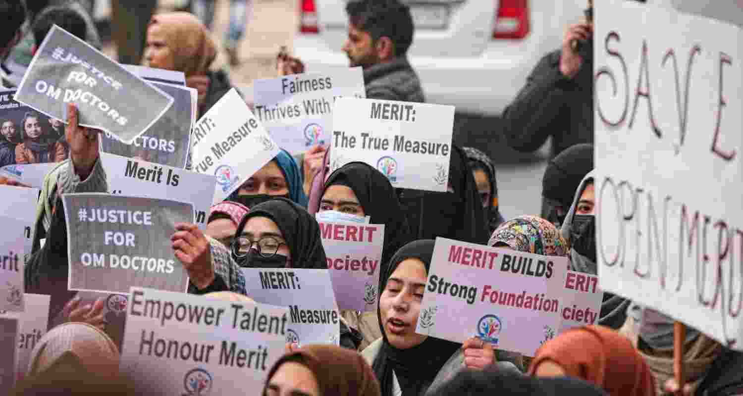 Medical students hold posters during a protest, led by Aga Syed Ruhullah Mehdi (unseen), demanding rationalisation of reservation in Jammu and Kashmir, outside J&K Chief Minister Omar Abdullah’s residence in Srinagar, Monday. Medical students hold posters during a protest, led by Aga Syed Ruhullah Mehdi (unseen), demanding rationalisation of reservation in Jammu and Kashmir, outside J&K Chief Minister Omar Abdullah’s residence in Srinagar, Monday.