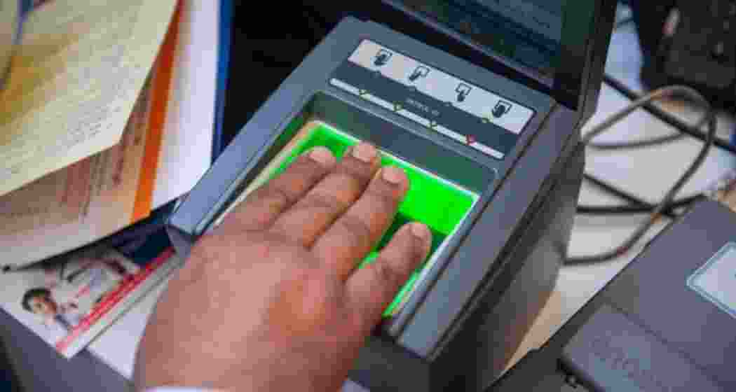 A customer undergoing Aadhaar verification at a service centre. A customer undergoing Aadhaar verification at a service centre.