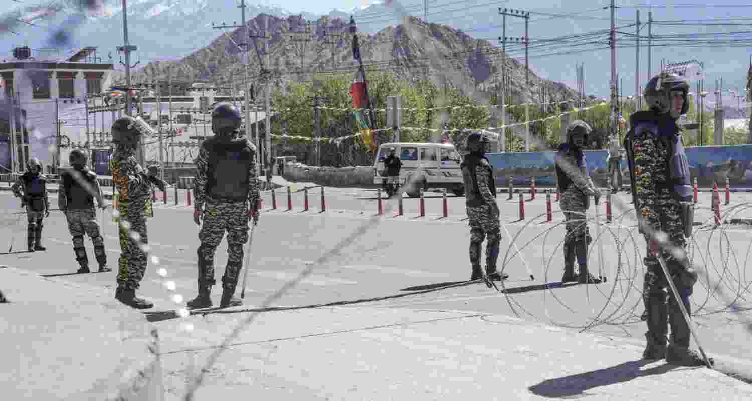 Security personnel stand guard on a road amid curfew, days after violence during protests for Ladakh Statehood, in Leh on Tuesday. Security personnel stand guard on a road amid curfew, days after violence during protests for Ladakh Statehood, in Leh on Tuesday.