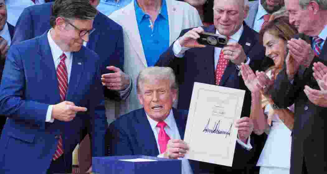 US President Donald Trump displays the signed bill during a ceremony for the One Big Beautiful Bill Act on the South Lawn of the White House in Washington on July 4. US President Donald Trump displays the signed bill during a ceremony for the One Big Beautiful Bill Act on the South Lawn of the White House in Washington on July 4.