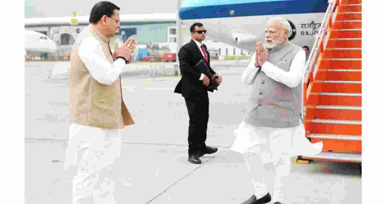 Uttarakhand Chief Minister Pushkar Singh Dhami welcomes PM Modi at Jolly Grant Airport in Dehradun on Thursday. Uttarakhand Chief Minister Pushkar Singh Dhami welcomes PM Modi at Jolly Grant Airport in Dehradun on Thursday.