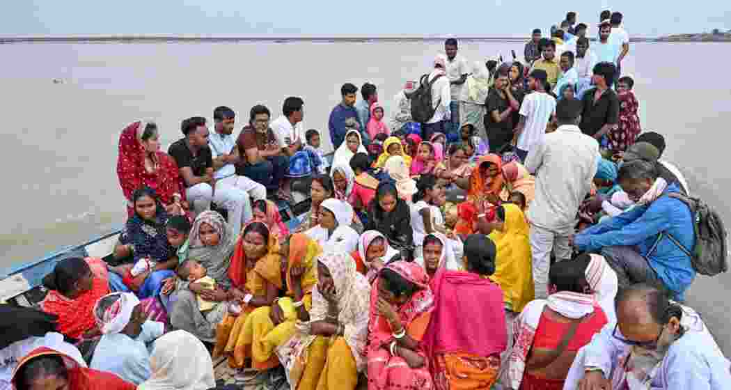 People cross the Brahmaputra river on a boat to casts their votes in the Assam Assembly elections, in Darrang, on Thursday. People cross the Brahmaputra river on a boat to casts their votes in the Assam Assembly elections, in Darrang, on Thursday.