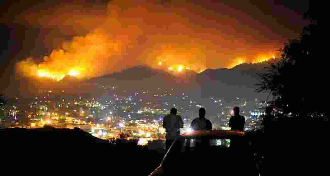 Onlookers watch from a distance as wildfires continue to ravage Los Angeles, leaving a trail of destruction with homes, vehicles, and neighbourhoods reduced to ash, leaving 11 dead and thousands displaced. Onlookers watch from a distance as wildfires continue to ravage Los Angeles, leaving a trail of destruction with homes, vehicles, and neighbourhoods reduced to ash, leaving 11 dead and thousands displaced.
