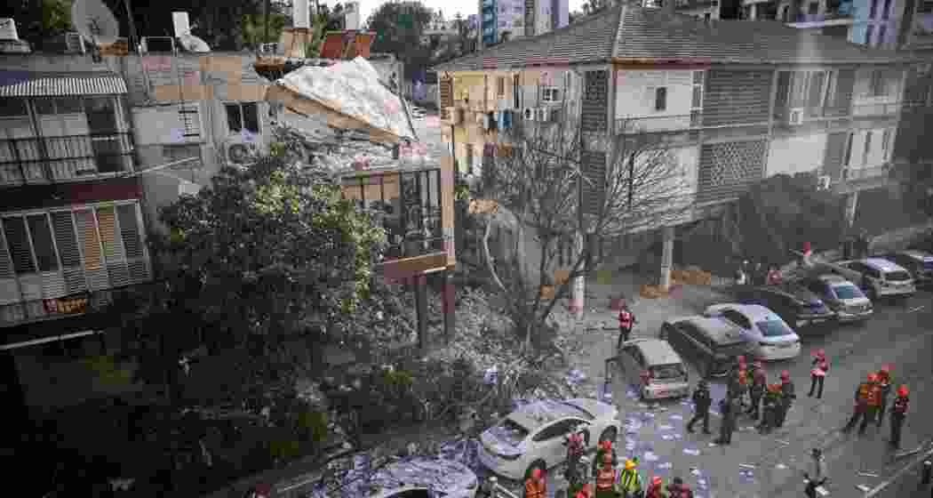 Officers from Israel's Home Front Command inspect a damaged apartment building after an Iranian missile strike in Ramat Gan, Israel, on Tuesday. Officers from Israel's Home Front Command inspect a damaged apartment building after an Iranian missile strike in Ramat Gan, Israel, on Tuesday.